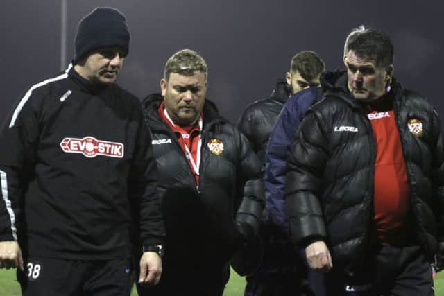 Marcus Law (left) and his backroom staff talk things over following the Poppies' success at the weekend