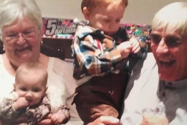 Susan and Bryan with grandchildren Finley and Connie.