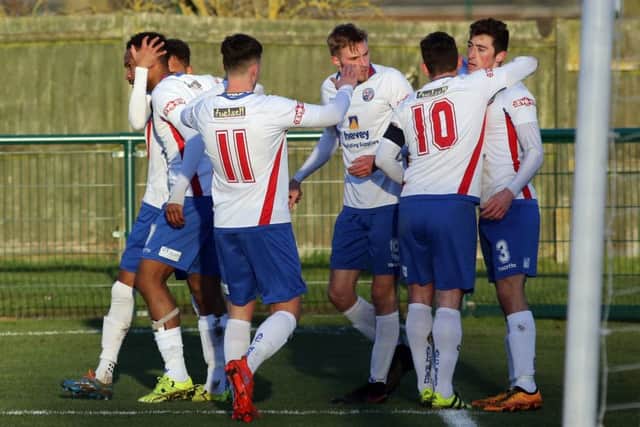Sam Brown takes the congratulations after he opened the scoring for Diamonds