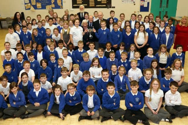 Pupils from Years 4 and 6 at Whitefriars Junior School with the Poppy Cup and members of Rushden RBL