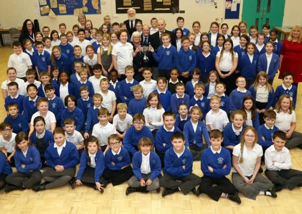 Pupils from Years 4 and 6 at Whitefriars Junior School with the Poppy Cup and members of Rushden RBL