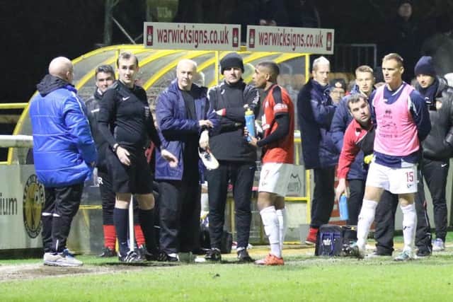 Paul Holleran in discussion with the referee and Kettering bench after the lights went out on Tuesday evening.