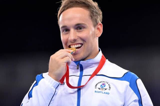 Dan Keatings on the podium after winning gold for Scotland at the 2014 Commonwealth Games