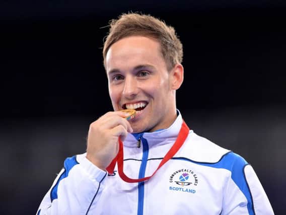 Dan Keatings on the podium after winning gold for Scotland at the 2014 Commonwealth Games