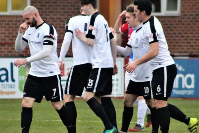 Corby Town's players celebrate Ryan Bell's winning goal in last weekend's 1-0 success at Ilkeston. Picture by David Tilley