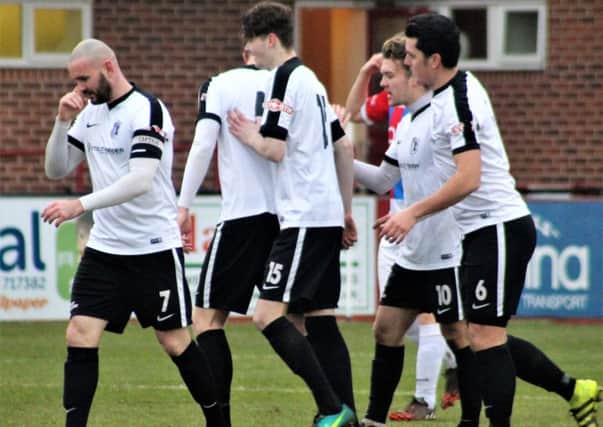 Corby Town's players celebrate Ryan Bell's winning goal in last weekend's 1-0 success at Ilkeston. Picture by David Tilley