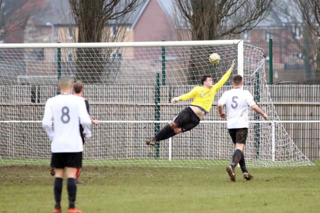 Remy Brittain scores one of Whitworth's goals during the 2-2 draw with Bugbrooke in UCL Division One last weekend. Pictures by Alison Bagley