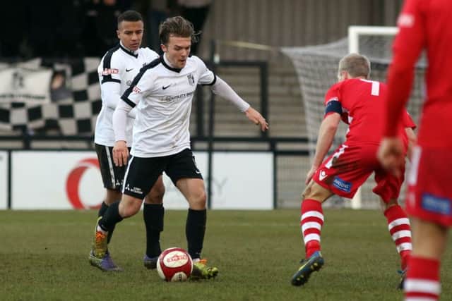Ben Milnes runs at a Hednesford opponent