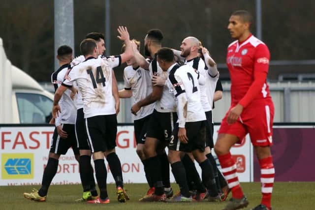 The Corby Town players celebrate Aaron Brown's late winner against Hednesford Town. Picture by Alison Bagley