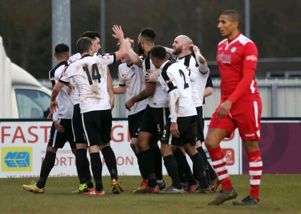 The Corby Town players celebrate Aaron Brown's late winner against Hednesford Town. Picture by Alison Bagley