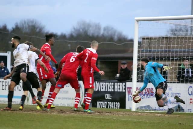 Aaron Brown's header beats Hednesford goalkeeper Dan Crane for Corby Town's late winner