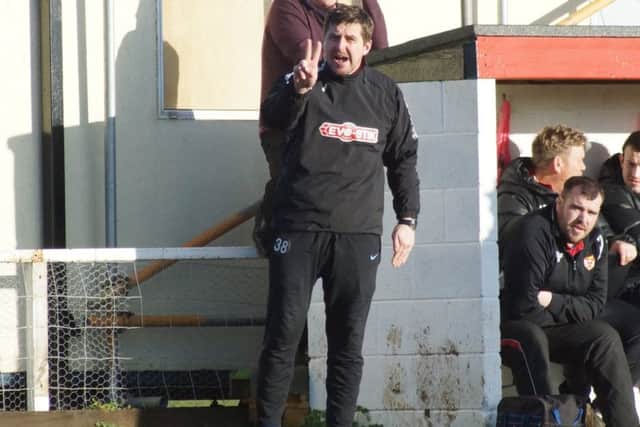Boss Marcus Law dishes out some instructions from the dugout