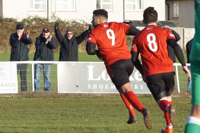 Rene Howe heads off to celebrate after he scored the second goal in Kettering Town's 3-1 victory over Biggleswade Town at Latimer Park. Pictures by Peter Short