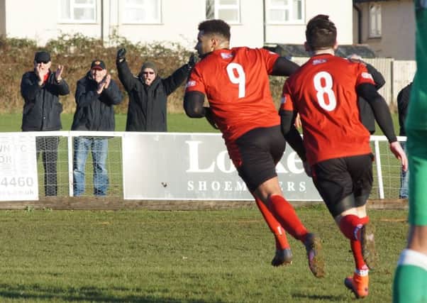 Rene Howe heads off to celebrate after he scored the second goal in Kettering Town's 3-1 victory over Biggleswade Town at Latimer Park. Pictures by Peter Short