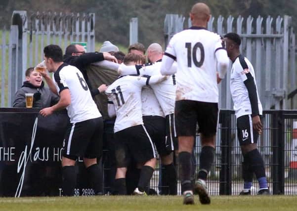 Jason Lee enjoys a little drink as Corby Town celebrate Ben Milnes' winning goal against Mickleover Sports. Pictures by Alison Bagley