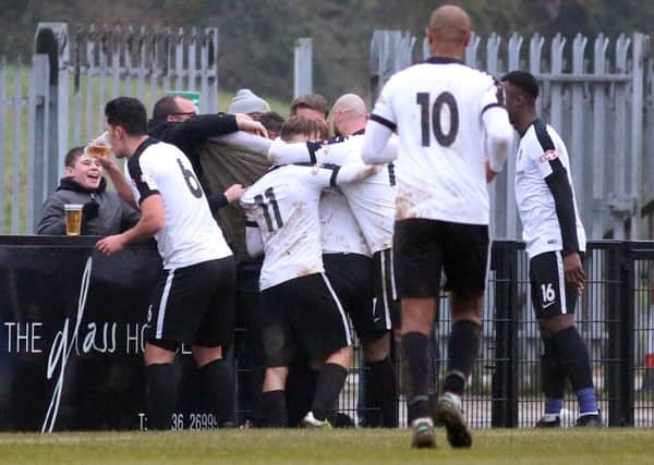 It's the picture that has taken the football world by storm over the weekens as Corby Town defender Jason Lee has a cheeky swig of a supporter's pint after Ben Milnes hit what proved to be the winner against Mickleover Sports. Picture by Alison Bagley