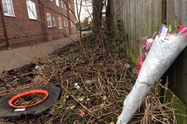 Flowers are being laid at the alleyway connecting St George's Street and Aldbury Court where the incident took place.