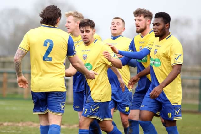 Barry Deacon takes the congratulations after scoring one of his two goals in Wellingborough Town's 3-0 win over Oadby Town last weekend. Picture by Alison Bagley