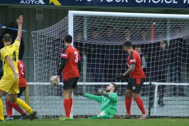 Kettering Town goalkeeper Paul White is unable to keep out Phil Roberts' opening goal for Chesham United in their 2-1 success at Latimer Park. Pictures by Peter Short