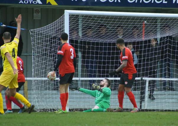 Kettering Town goalkeeper Paul White is unable to keep out Phil Roberts' opening goal for Chesham United in their 2-1 success at Latimer Park. Pictures by Peter Short