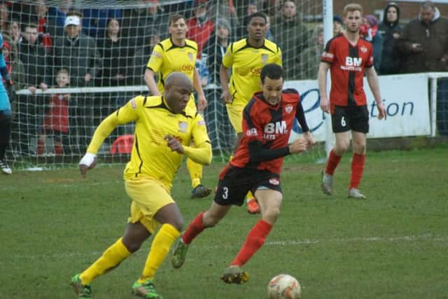 Poppies defender Dominic Langdon challenges Chesham's veteran striker Barry Hayles