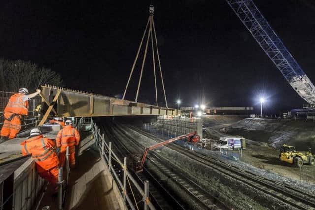 One of the beams being lifted into place