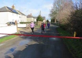 Jenny Betts (On the right - President of Caldecott WI) winning the grand final of the ladies race