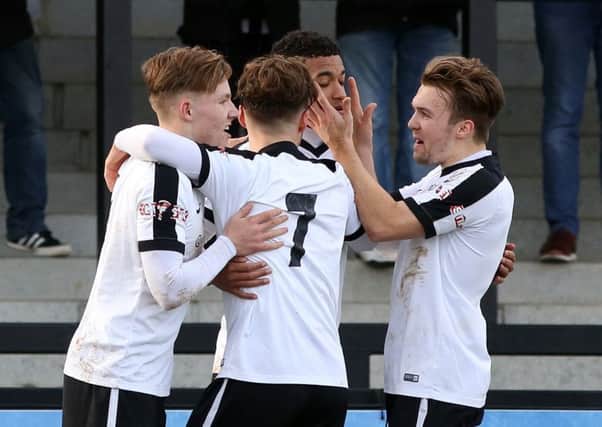 Jordon Crawford takes the congratulations after scoring one of his two goals in Corby Town's 3-0 win over Skelmersdale United. Pictures by Alison Bagley