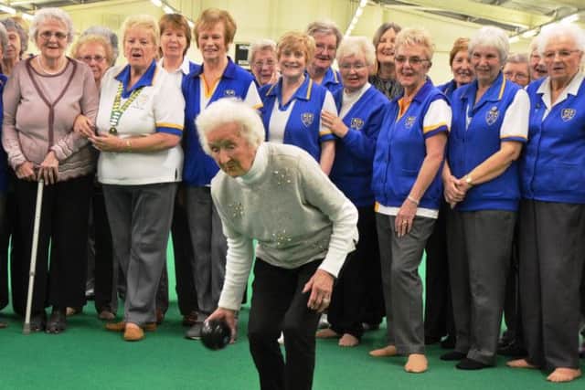 Marjorie Wright is supported by members at Kettering Lodge as she bowls to celebrate her 100th birthday