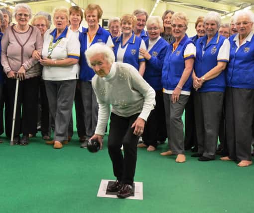 Marjorie Wright is supported by members at Kettering Lodge as she bowls to celebrate her 100th birthday
