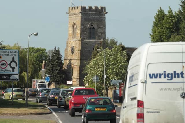 Heavy traffic on the A509 road through the small village of Isham in Northamptonshire. The village is still waiting on a bypass ENGNNL00120110405170305