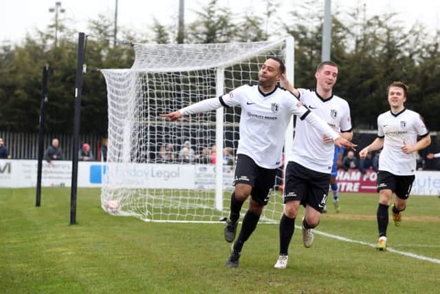 Spencer Weir-Daley strikes his familiar pose after scoring Corby's fourth goal at Steel Park