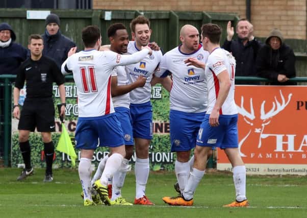 The AFC Rushden & Diamonds players celebrate Nabil Shariff's winning goal in their 2-1 win over Leek Town. Pictures by Alison Bagley