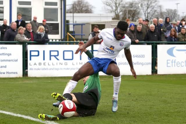 Diamonds winger Shawn Richards is challenged by Leek Town defender