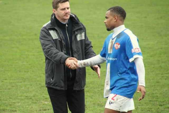 Poppies boss Marcus Law shakes hands with Liam Bateman following the 3-3 draw at Frome Town. Pictures by Peter Short
