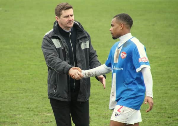 Poppies boss Marcus Law shakes hands with Liam Bateman following the 3-3 draw at Frome Town. Pictures by Peter Short