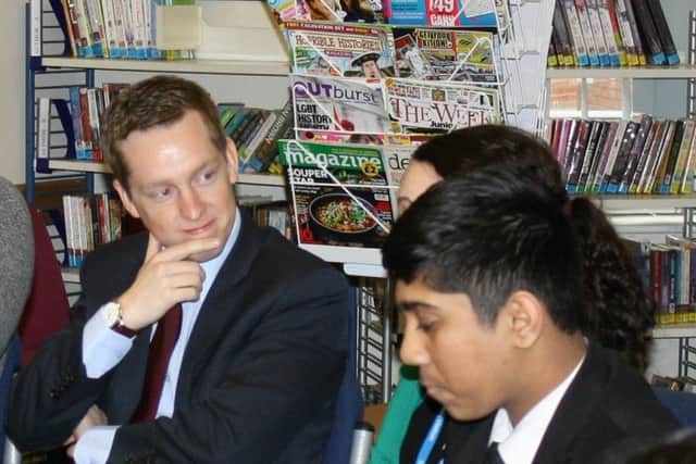 Tom chats to pupils.