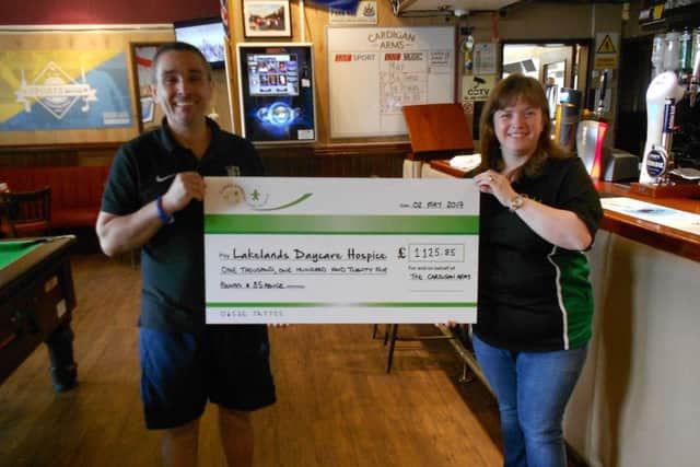 Marina Rae receiving the cheque from the pub on behalf of the hospice