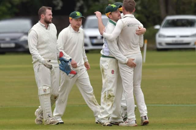 Overstone Park's players celebrate a wicket in their nine-wicket division one win over Isham (Pictures: Dave Ikin)