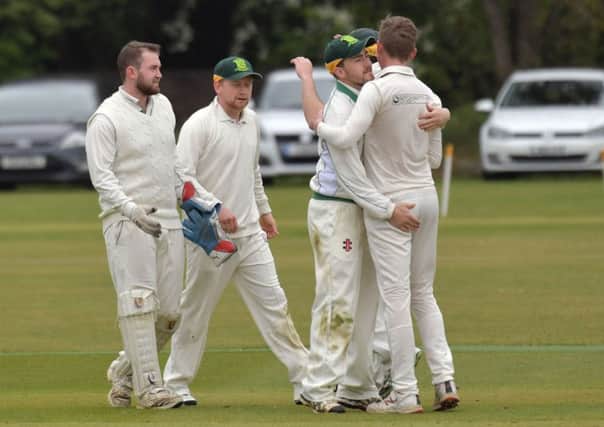 Overstone Park's players celebrate a wicket in their nine-wicket division one win over Isham (Pictures: Dave Ikin)