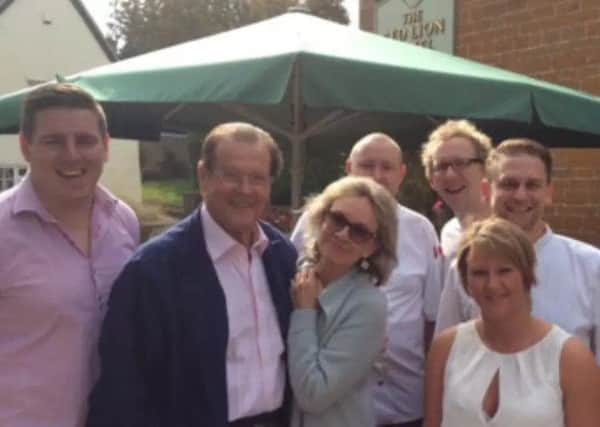 Sir Roger Moore at The Red Lion pub in East Haddon in 2014