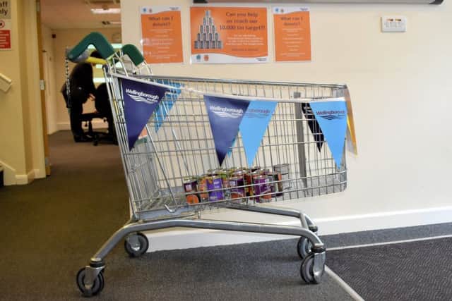 Could you help fill this trolley with tins?