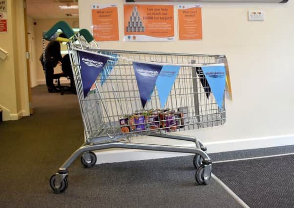 Could you help fill this trolley with tins?
