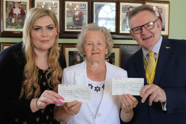 Cllr Pam Whiting handing over the cheques to her chosen charities