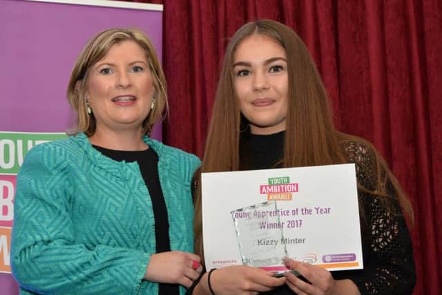 Angela Hackett of Guidant presents Kizzy Minter with the Young Apprentice of the Year Award.