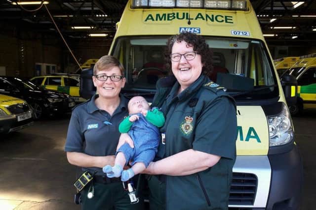 Technicians Sharon and Carolyn with baby Isaac.