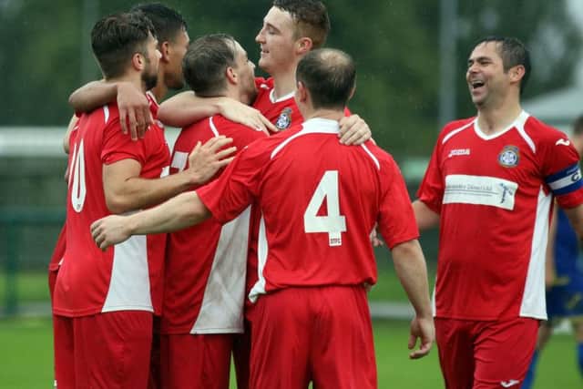 Desborough Town celebrate one of their six goals at the Dog & Duck