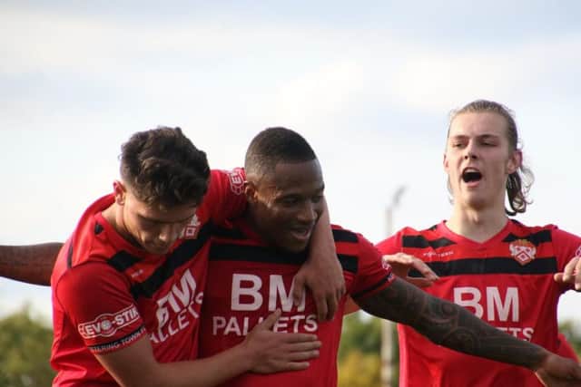 Aaron O'Connor is congratulated by Mathew Stevens and Ben Toseland after he sealed Kettering Town's win over Chesham United at Latimer Park. Pictures by Peter Short
