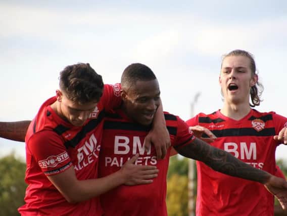 Aaron O'Connor is congratulated by Mathew Stevens and Ben Toseland after he sealed Kettering Town's win over Chesham United at Latimer Park. Pictures by Peter Short