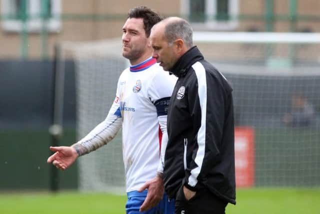 Andy Peaks and midfielder Richard Bunting talk things over following AFC Rushden & Diamonds' FA Trophy loss to Kidsgrove Athletic at the weekend. Pictures by Alison Bagley